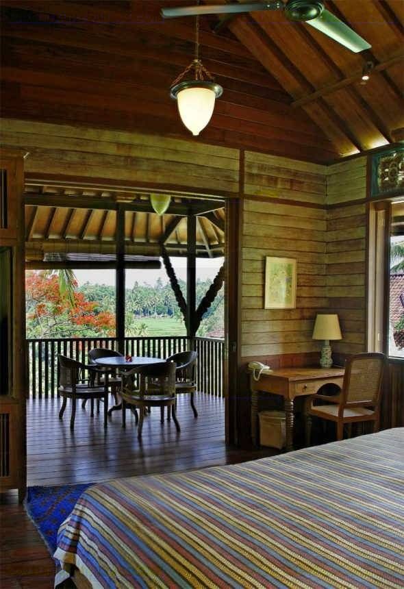 Master bedroom at Villa Kirana opening to a covered deck with rice-field views