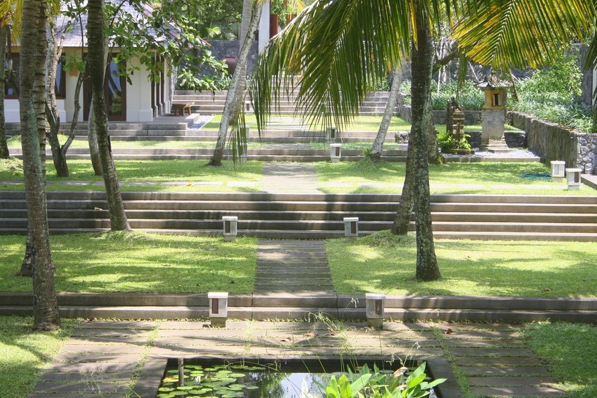 Terraced garden steps leading down to a lily pond at Villa Lalang