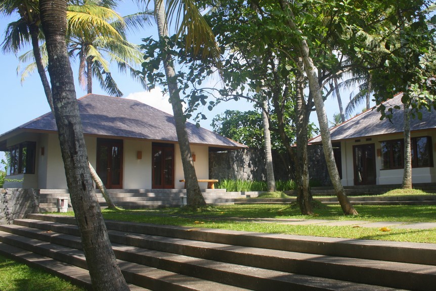 One of Villa Lalang's guest bungalows tucked among palm trees on the grounds