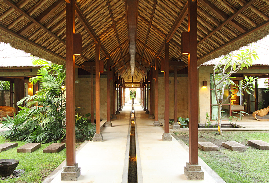 The entrance corridor at Villa Melissa, with water running alongside the walkway to the sea
