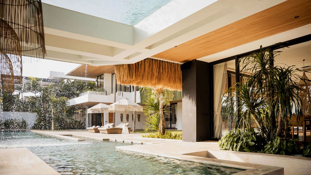 Relaxing pool area at Villa Nica with lounge seating and villa architecture