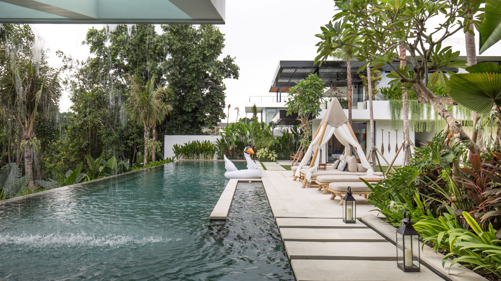 Villa Norbu's pool terrace opening onto rice fields under an open sky