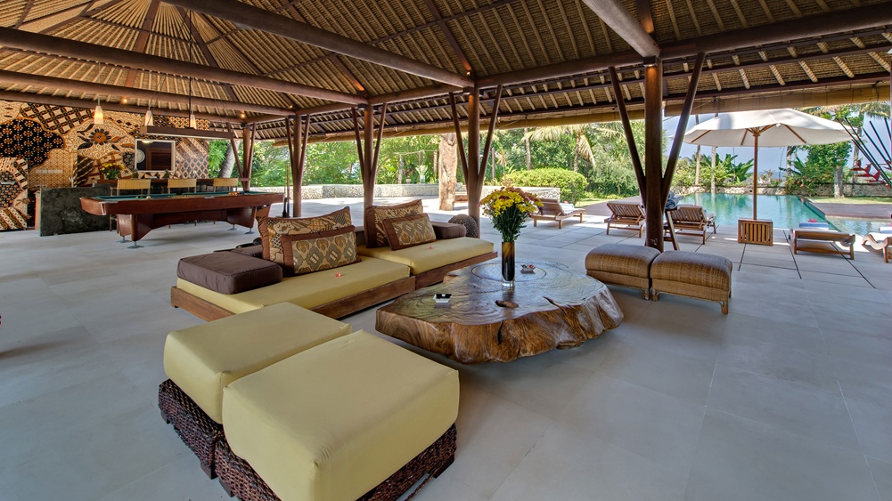 The entertainment pavilion at Villa Samadhana, with a billiard table opening onto the pool and gardens