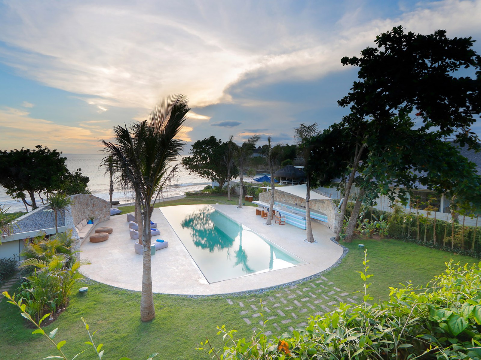 Villa Seascape and its lawn and pool at dusk on Sandy Bay, Nusa Lembongan, Bali