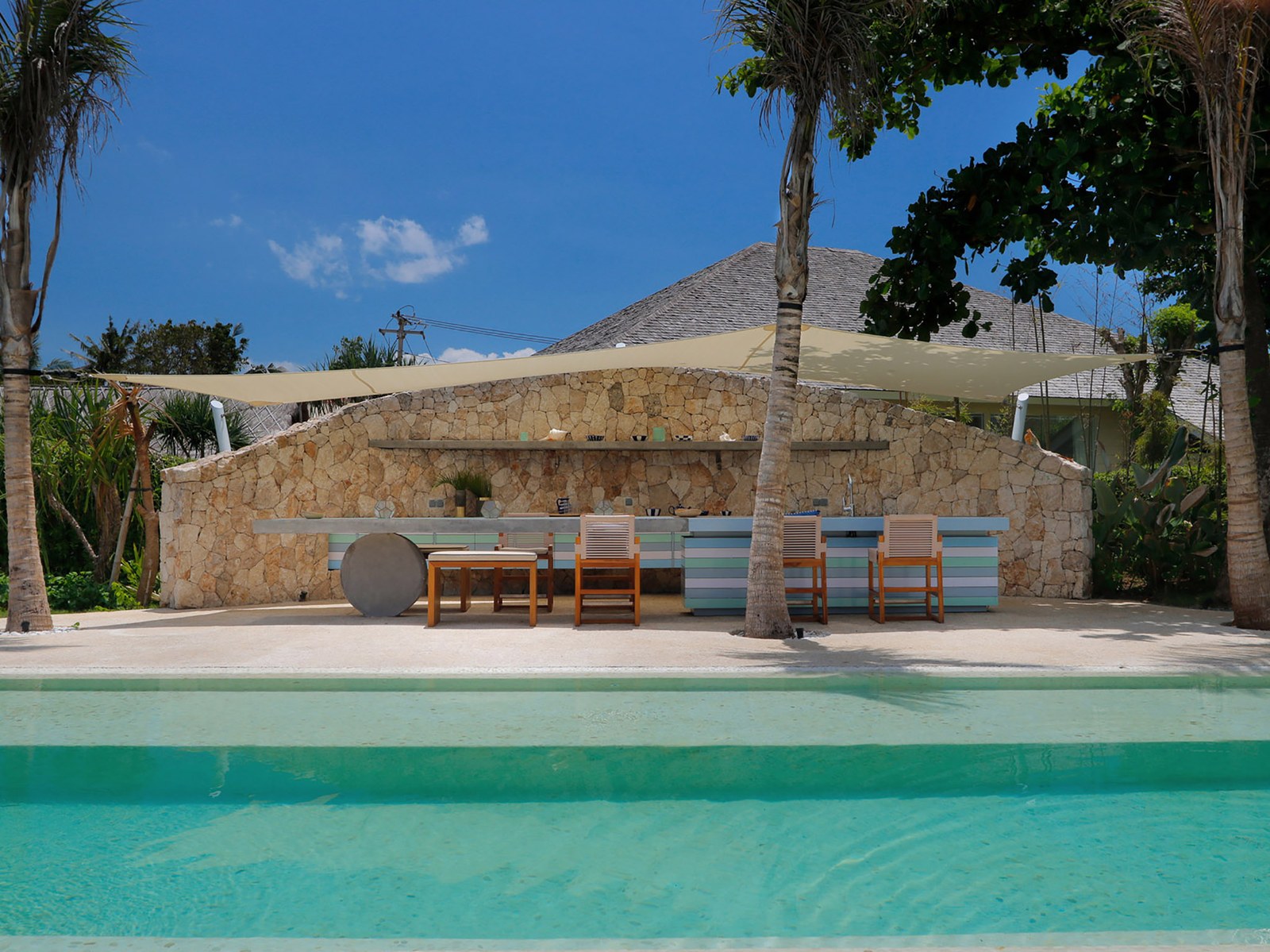 Poolside bar and entertainment terrace under umbrellas at Villa Seascape on Nusa Lembongan, Bali
