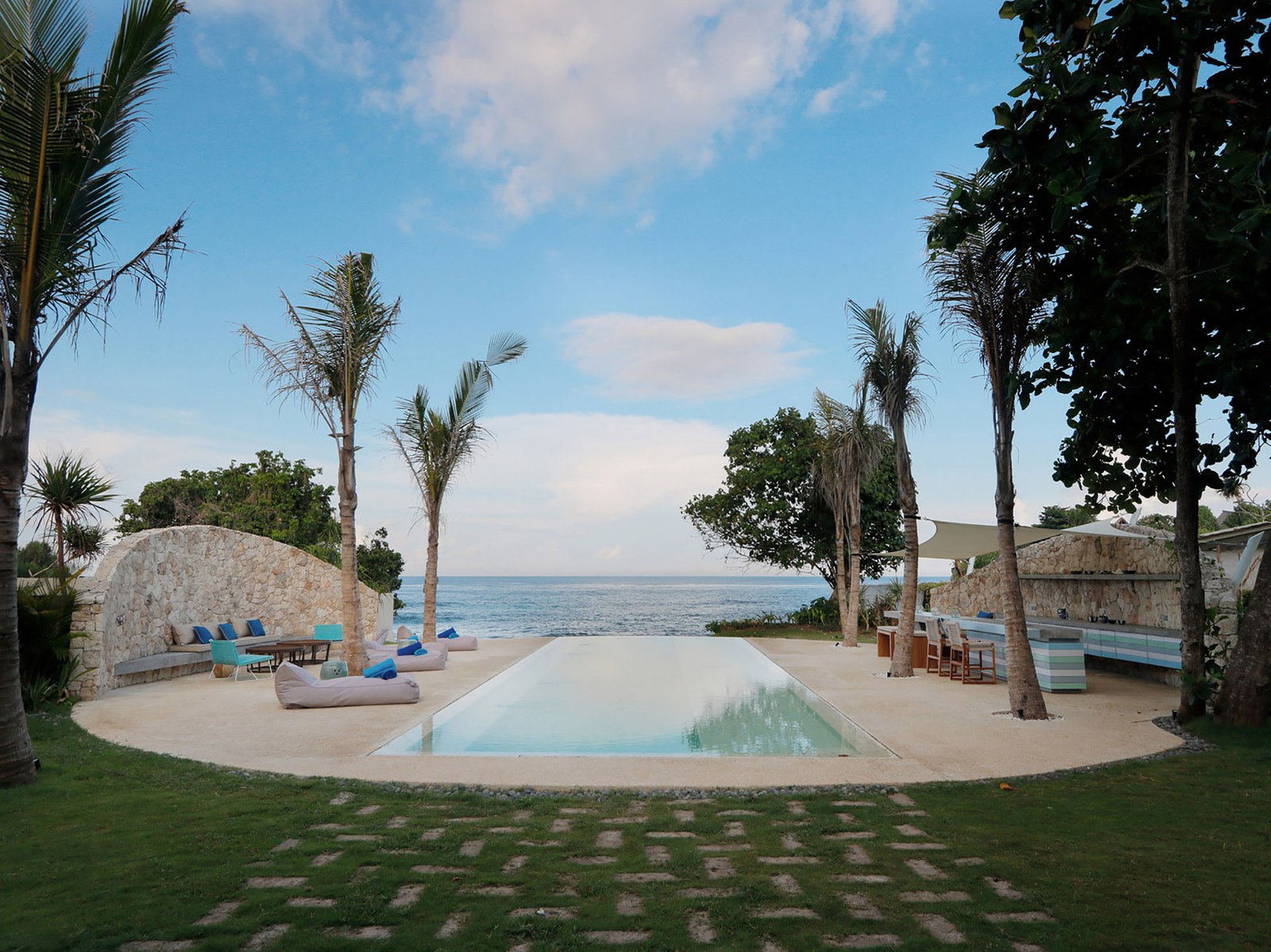 Oceanfront pool and daybeds looking out to the sea at Villa Seascape on Sandy Bay, Nusa Lembongan, Bali