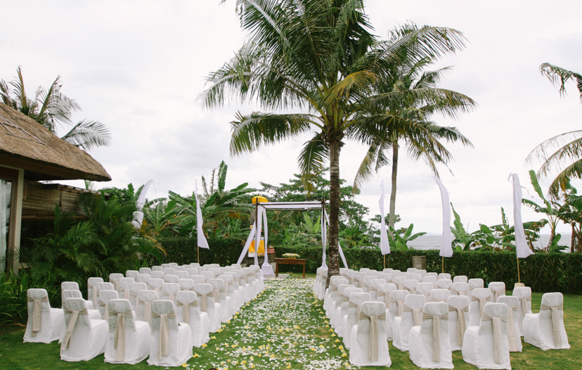 Rows of ceremony chairs on the Villa Shalimar lawn facing the garden