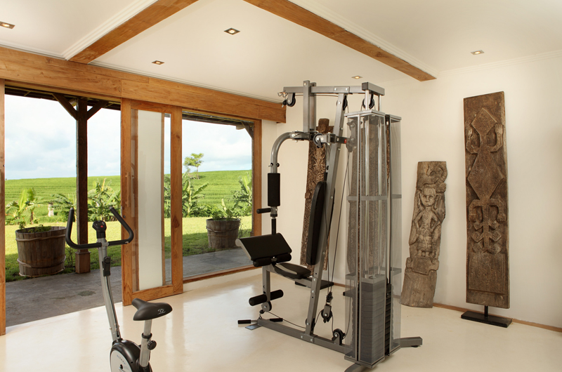 The gym pavilion at Villa Tangguntiti opening to open rice fields
