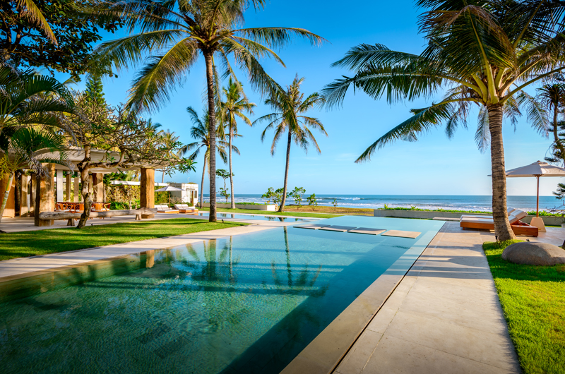 Open pavilion and pool at Villa Vedas with the beachfront garden beyond
