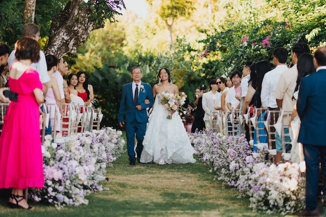Wedding ceremony with arch and florals at Wonderland Uluwatu, Bali